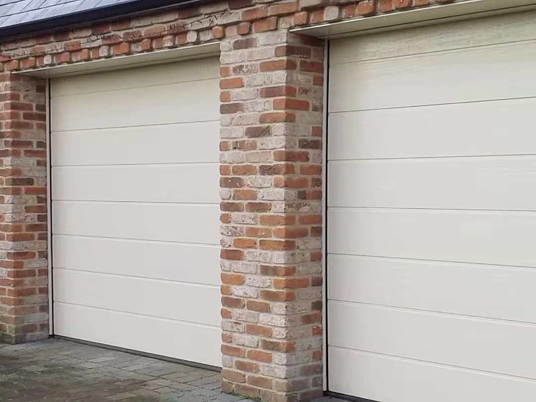 White sectional doors in a brick facade